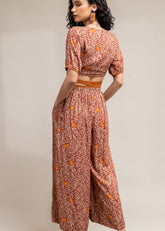 A Model Wearing Brown Upcycled Cotton  Rehno Printed Trousers, curated by Only Ethikal